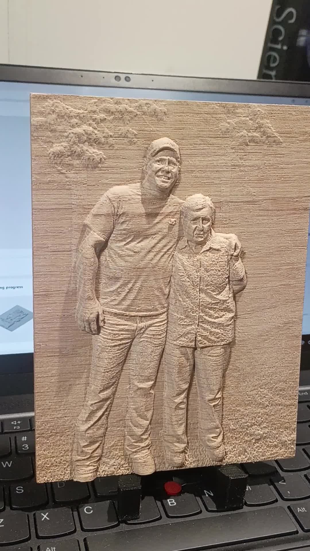 A custom wood photo relief on its display stand in the Webb Works workshop
